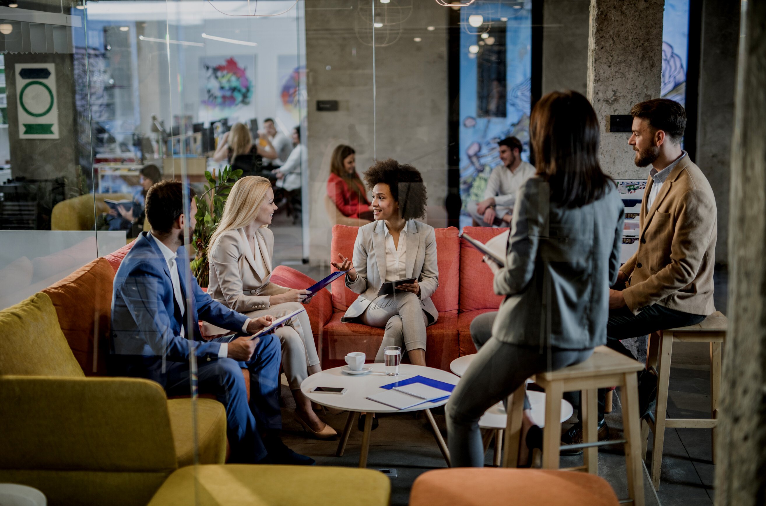 Group of entrepreneurs having staff meeting at casual office.